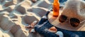 Straw hat towel and sunglasses lie on the sand Royalty Free Stock Photo