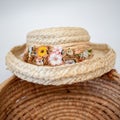 Straw hat trimmed in dried flowers on top of woven basket