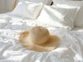 Straw Hat On White Bed In Sunlight Royalty Free Stock Photo
