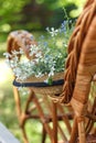 Straw Hat, White Flowers And A Wicker Chair In The Garden. Summer Vacation Outside The City