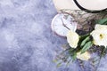 Straw hat, white roses and alarm clock