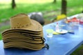 Straw hats on blue table in forest. Royalty Free Stock Photo