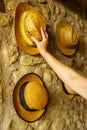 Straw hats hanging on the wall of an old retro-style house reminiscent of times gone by.