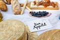 Straw hats lay on a white picnic blanket next to nameplate bon apetit bright summer day background. Summer weekends leisure