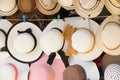 Straw hats for sale, hanging on a wall