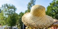 Straw hats in sunshine on a heap for sale