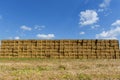 Straw or hay stacked in a field after harvesting. Straw bale wall.