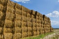 Straw or hay stacked in a field after harvesting. Straw bale wall.