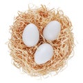 Straw nest filled with white eggs, top view isolated on white background. Happy Easter decorations, template for tag, gift