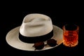 Panama Hat with Sunglasses and Drink on a Black Background