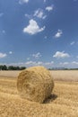 Straw roll bales with crop field, photovoltaic panel and blue sky in background Royalty Free Stock Photo