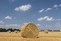 Straw roll bales with crop field, photovoltaic panel and blue sky in background Royalty Free Stock Photo