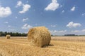 Straw roll bales with crop field, photovoltaic panel and blue sky in background Royalty Free Stock Photo