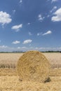 Straw roll bales with crop field, photovoltaic panel and blue sky in background Royalty Free Stock Photo