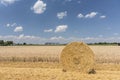 Straw roll bales with crop field, photovoltaic panel and blue sky in background Royalty Free Stock Photo