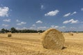Straw roll bales with crop field, photovoltaic panel and blue sky in background Royalty Free Stock Photo