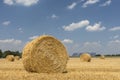 Straw roll bales with crop field, photovoltaic panel and blue sky in background Royalty Free Stock Photo