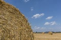 Straw roll bales detail with crop field, photovoltaic panel and blue sky in background Royalty Free Stock Photo