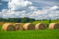 Straw roll on a green field with a beautiful sky Royalty Free Stock Photo