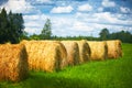 Straw roll on a green field with a beautiful sky Royalty Free Stock Photo