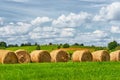 Straw roll on a green field with a beautiful sky Royalty Free Stock Photo