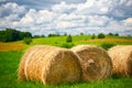 Straw roll on a green field with a beautiful sky Royalty Free Stock Photo