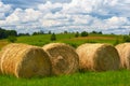 Straw roll on a green field with a beautiful sky Royalty Free Stock Photo