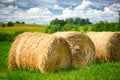 Straw roll on a green field with a beautiful sky Royalty Free Stock Photo