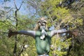 The straw scarecrow among the green trees Royalty Free Stock Photo