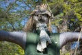 The straw scarecrow among the green trees Royalty Free Stock Photo