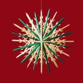 Straw star Christmas decoration over red