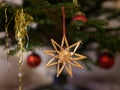 A straw star hanging on the christmas tree Royalty Free Stock Photo