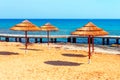 straw sun umbrellas at tropical beach Royalty Free Stock Photo