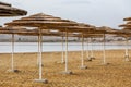 Straw sunshades at Dead Sea beach Royalty Free Stock Photo