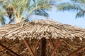 Straw umbrella at beach resort against blue sky. Close up. Abstract vacation and holiday background Royalty Free Stock Photo