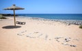 Umbrella with the word love made of stones near beach in tenerife. Royalty Free Stock Photo