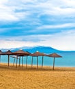 A straw umbrella on a tropical beach with sky