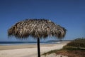 Straw Umbrella on a wide open beach.