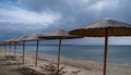 Straw umbrellas and beach chairs on a sandy beach Royalty Free Stock Photo