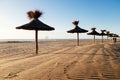 Straw umbrellas beach in perspective. Royalty Free Stock Photo