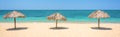 Straw umbrellas on a beautiful tropical beach, panoramic travel background, travel and tourism concept Royalty Free Stock Photo