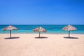 Straw umbrellas on a beautiful tropical beach Royalty Free Stock Photo