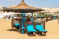 Straw umbrellas and deck chairs in a Red Sea beach - Marsa Alam Egypt Africa Royalty Free Stock Photo