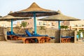 Straw umbrellas and deck chairs in a Red Sea beach - Marsa Alam Egypt Africa Royalty Free Stock Photo