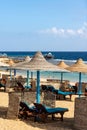 Straw umbrellas and deck chairs in a Red Sea beach - Marsa Alam Egypt Africa Royalty Free Stock Photo