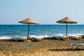 Straw umbrellas on empty seaside beach in Turkey