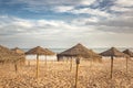 Straw umbrellas on a sandy beach. Relaxing day on a exotic beach in summer. Royalty Free Stock Photo