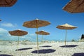 Straw umbrellas with shadow on the beach