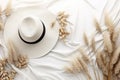 straw weaved hat with dry leaves and wild flowers. Bohemian background, boho flat lay composition Royalty Free Stock Photo