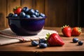 strawberies and blue barries in the bowl on the table